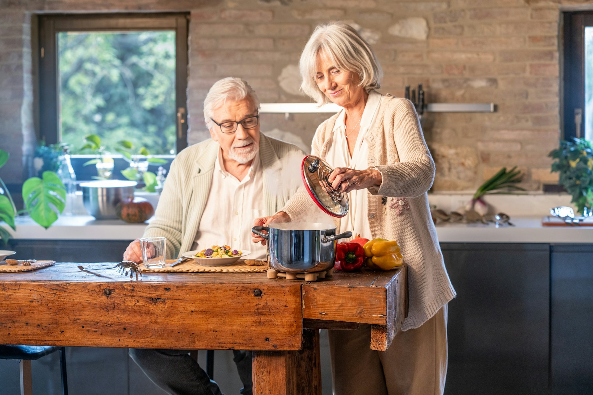 Older couple cooking together in a home kitchen